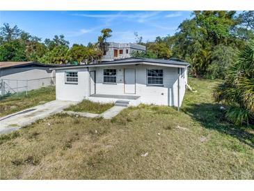Charming single-story home featuring a well-maintained front yard and classic architectural details at 111 W Keyes Ave, Tampa, FL 33602