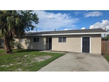 Charming single-story home with stucco siding, a well-manicured lawn, and mature tree at 1120 Union S St, St Petersburg, FL 33712