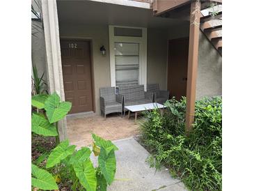 Comfortable patio seating area with a small table outside unit 102 at 14219 Shadow Moss Ln # 102, Tampa, FL 33613