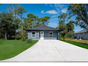 Charming single story home featuring a large driveway and a well manicured lawn at 163 Swift St, Port Charlotte, FL 33954