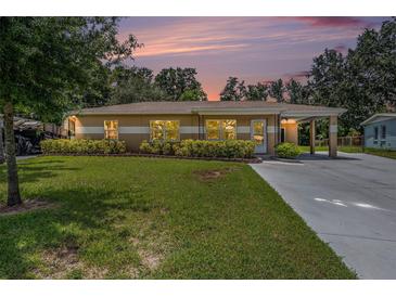 Charming single-story home with a well-manicured lawn and a convenient carport at 4816 N Fremont Ave, Tampa, FL 33603