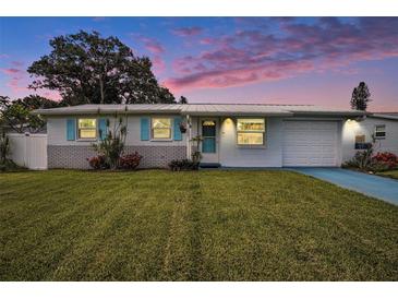 Charming single-story home with a well-manicured lawn, blue shutters, and a freshly painted exterior at 11416 126Th N Ave, Largo, FL 33778