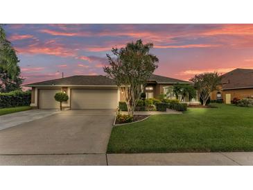 Charming single Gathering home featuring a three-car garage and well-manicured lawn at 2202 Hickory Ridge Dr, Valrico, FL 33596