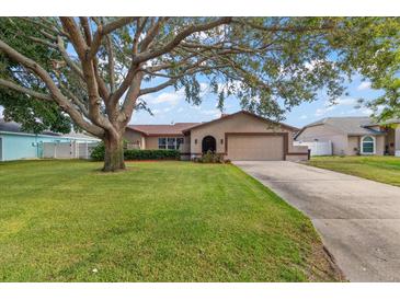 Charming single-story home featuring a spacious lawn and a large shade tree in the front yard at 2584 58Th S Ave, St Petersburg, FL 33710