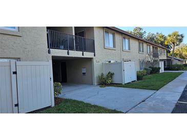Well-maintained exterior with lush landscaping, private patios, and assigned parking at 4215 E Bay Dr # 1506C, Clearwater, FL 33764