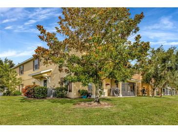Charming home featuring a spacious green lawn and a beautiful, mature tree in the front yard at 4703 Somerset Hill Ln, Riverview, FL 33578