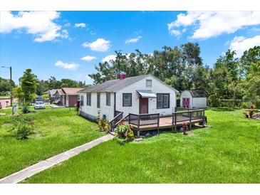 Charming single-story home with a cozy front porch and well-maintained lawn at 812 W Orient St, Tampa, FL 33603