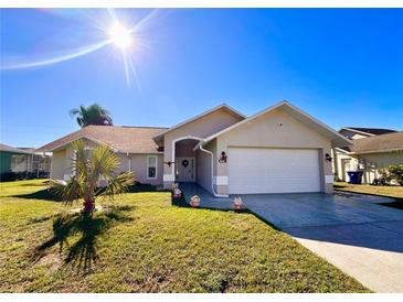 Charming single-story home featuring a well-manicured lawn and an attached two-car garage at 8616 Pinafore Dr, New Port Richey, FL 34653
