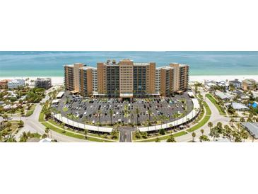 Stunning aerial view of beachfront condo building with manicured grounds and ample parking at 880 Mandalay Ave # C512, Clearwater Beach, FL 33767