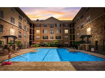 Beautiful pool area surrounded by multi-story apartment buildings at sunset at 4221 W Spruce St # 2328, Tampa, FL 33607