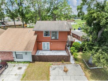 Charming two-story home featuring a spacious backyard and a private outdoor patio area at 10520 Winrock Pl, Tampa, FL 33624