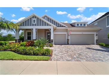 Beautiful single-Gathering home featuring a well-manicured front yard, two-car garage, and charming architectural details at 7520 Paradiso Dr, Apollo Beach, FL 33572