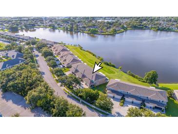 Scenic aerial view of waterfront townhomes, surrounded by lush landscaping and calm lake waters at 8251 118Th Ave # 8251, Largo, FL 33773