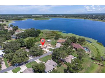 Stunning aerial view of lakeside home with lush greenery and scenic surroundings at 271 Eastpoint Ct, Spring Hill, FL 34606