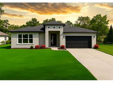 Charming single-story home featuring a modern design, well-manicured lawn, and a convenient two-car garage at 5352 Lowell Ave, Spring Hill, FL 34609