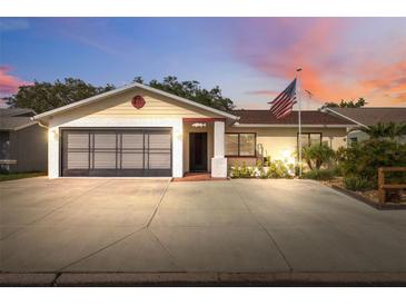 Charming single-story home with a two-car garage and well-manicured landscaping at 11422 Brown Bear Ln, Port Richey, FL 34668