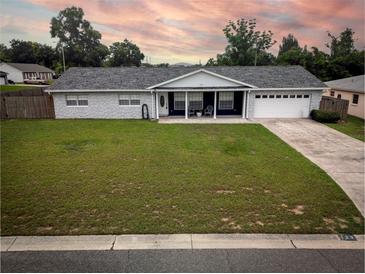 Charming single story home featuring manicured lawn, stone details, attached garage, and a covered front porch at 123 Jeffrey Dr, Brandon, FL 33511