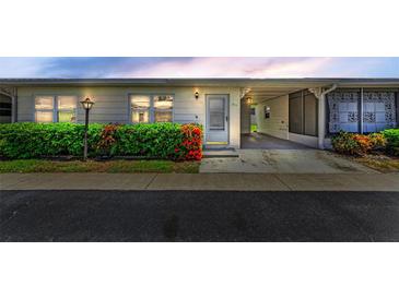 Charming home featuring a covered carport, well-maintained landscaping, and a welcoming entrance at 12400 Park Blvd # 311, Seminole, FL 33772
