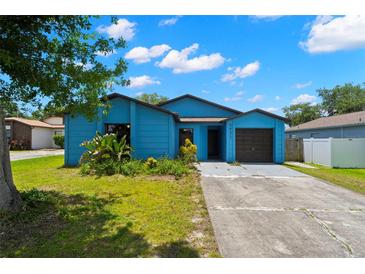 Charming blue single Gathering home with a well-kept lawn and driveway at 1421 Vinetree Dr, Brandon, FL 33510