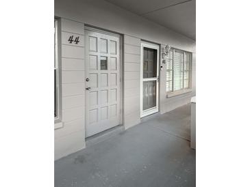 Apartment entryway featuring two doors with unit numbers and a neutral color scheme at 2460 Persian Dr # 44, Clearwater, FL 33763