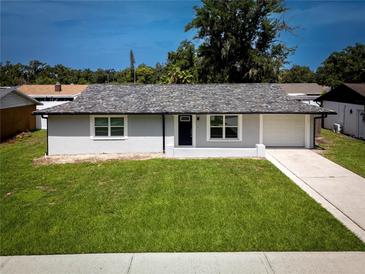 Charming single-story home with a well-maintained lawn and freshly painted exterior at 5018 Pine St, Seffner, FL 33584