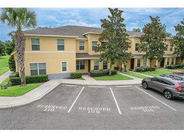Inviting two-story townhome featuring reserved parking, well-manicured landscaping, and a welcoming entrance at 6332 Timberly Ln, Zephyrhills, FL 33542