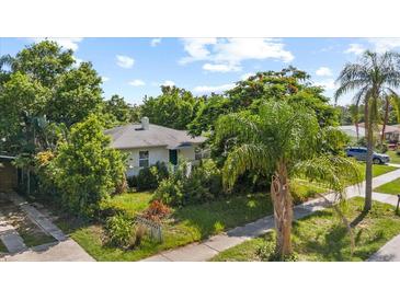 Charming single-story home with lush landscaping and mature trees in a serene setting at 1222 Palm St, Clearwater, FL 33755