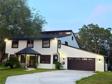 Charming two-story home with a well-manicured lawn, updated garage, and cozy covered entryway at 17926 Calkins Ct, Spring Hill, FL 34610