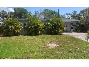 Quaint single-story home featuring mature landscaping in the front yard at 3927 Huntington Ne St, St Petersburg, FL 33703