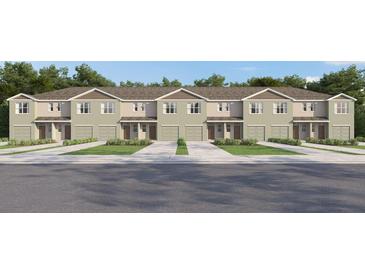 A row of townhouses, showcasing individual garages, neutral color palette, and manicured lawns at 17261 English Chestnut Way, Land O Lakes, FL 34638