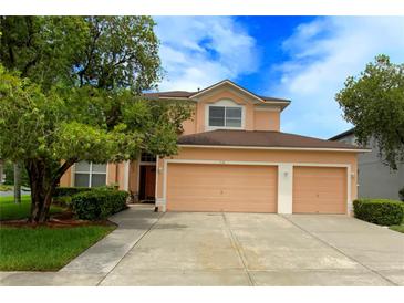 Charming two-story home with a three car garage and lush landscaping at 5154 Balsam Dr, Land O Lakes, FL 34639