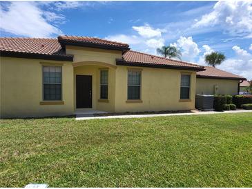 Charming single-story home featuring a well-manicured lawn and a welcoming entrance with a tiled roof at 5473 Sunset Falls Dr, Apollo Beach, FL 33572