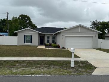 Charming single-story home with a well-manicured lawn and a two-car garage at 9397 Northcliffe Blvd, Spring Hill, FL 34606