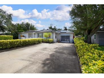 Charming single-story home with well-maintained landscaping, featuring a long driveway and attached garage at 101 N Corona Ave, Clearwater, FL 33765