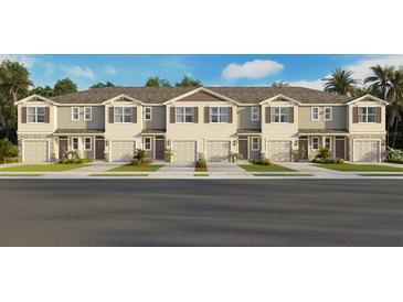 Charming townhome exterior featuring stone accents, a private garage, and manicured landscaping at 2466 Riversong Lodge Ln, Wesley Chapel, FL 33543