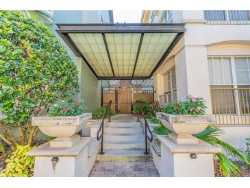 Inviting entryway with an attractive awning, manicured landscaping, and tiled stairs leading to the building's entrance at 501 S Moody Ave # 1134, Tampa, FL 33609