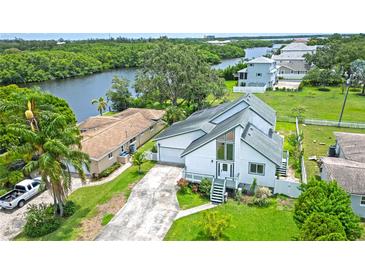 Beautiful two-story home featuring a modern design, lush landscaping, and ample parking at 8759 Orient Ne Way, St Petersburg, FL 33702