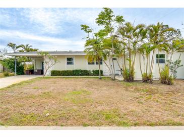 Charming single-story home featuring mature palm trees, and a covered carport at 4362 Wesley Ln, North Port, FL 34287