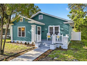 Charming teal bungalow with a quaint front porch and landscaped walkway at 4820 8Th S Ave, St Petersburg, FL 33711