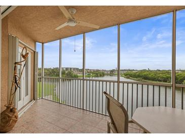 Relaxing screened balcony with tiled floor and beautiful lake view at 6450 Shoreline Dr Dr # 9202, St Petersburg, FL 33708