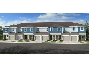 Attractive townhome with blue and light-blue color scheme, two stories, and individual garages at 13236 Stable Pl, Parrish, FL 34219