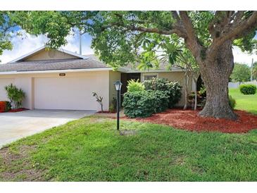 Charming single-story home with mature landscaping and a well-manicured lawn at 3568 Wilkinson Woods Dr # 23, Sarasota, FL 34231