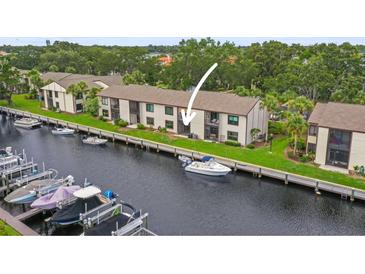 Waterfront condos with boat docks and lush landscaping provide access to the water and outdoor enjoyment at 358 Moorings Cove Dr # 4B, Tarpon Springs, FL 34689