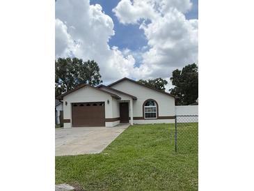 Charming single-story home showcasing a well-maintained lawn and a classic architectural style at 1900 W Kirby St, Tampa, FL 33604