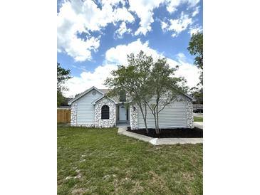 Charming home featuring stone accents and fresh landscaping, offering great curb appeal at 23220 Shining Star Dr, Land O Lakes, FL 34639