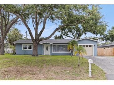 Charming single-story home with mature trees, a well-manicured lawn and a one-car garage at 11451 82Nd Ave, Seminole, FL 33772