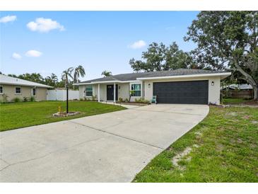 Charming single-story home with a well-maintained lawn and a long driveway leading to a two-car garage at 7108 14Th Nw Ave, Bradenton, FL 34209