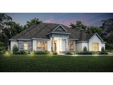 Charming single-Gathering home boasts a symmetrical facade, and a covered front porch set amidst a lush lawn at 13570 Saddlebred Ln, Hudson, FL 34667
