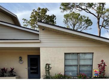 Charming home exterior featuring a well-manicured lawn and stucco facade at 3610 54Th W St # B8, Bradenton, FL 34209