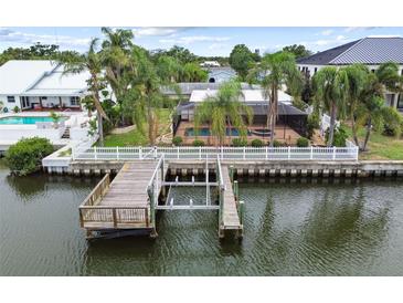Waterfront property with a private dock and boat lift, offering direct access to the open water at 3921 E Eden Roc Cir, Tampa, FL 33634